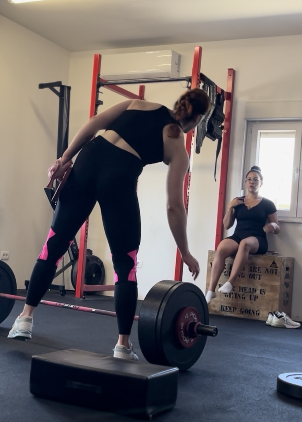 Woman lifting barbell seated